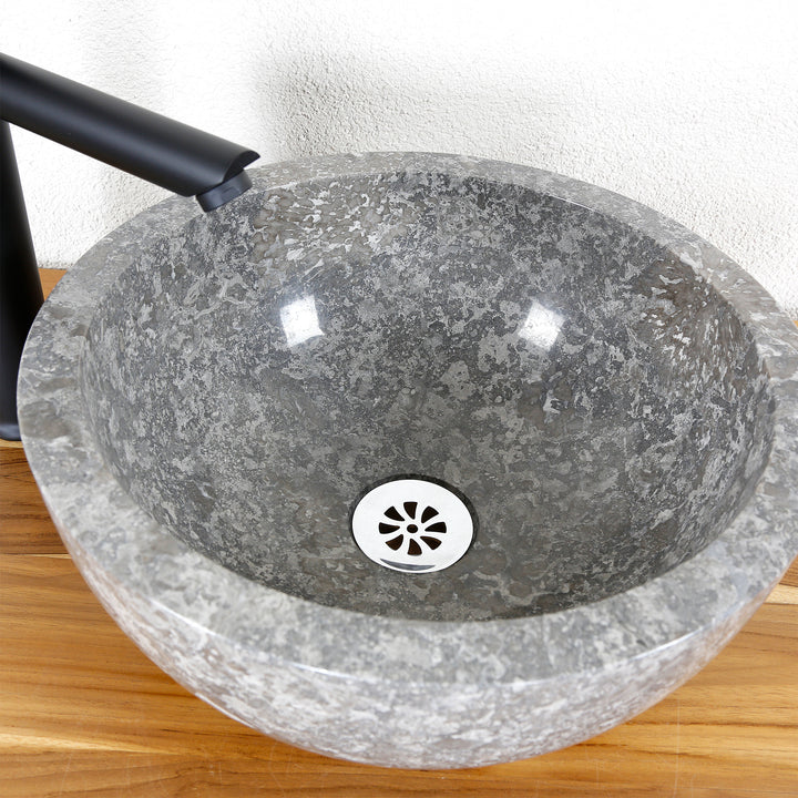 Countertop washbasin made of natural stone in gray, polished inside, round Washbasin with black fittings