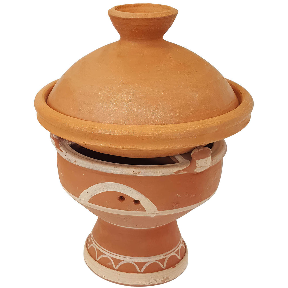 Tajine on a Moroccan clay warmer, mejmar for charcoal as a table grill for Tagine in Morocco style