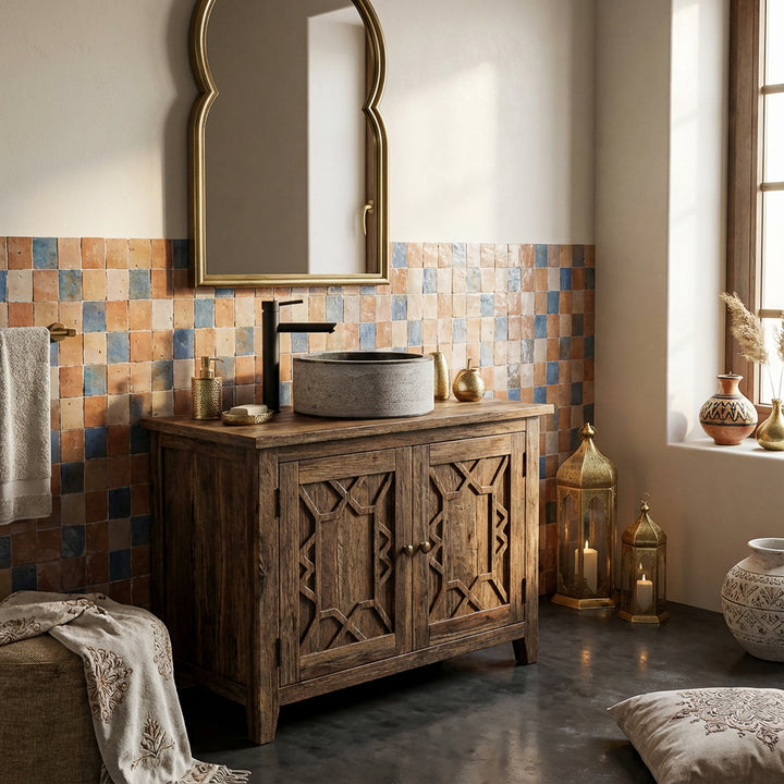 Round countertop washbasin made of stone on a wooden base cabinet, orientally staged with mosaic tiles and lanterns.