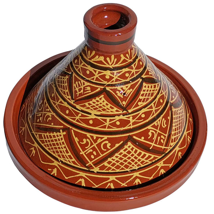 Glazed Moroccan Tajine made of clay with henna decoration, traditional casserole for aromatic recipes