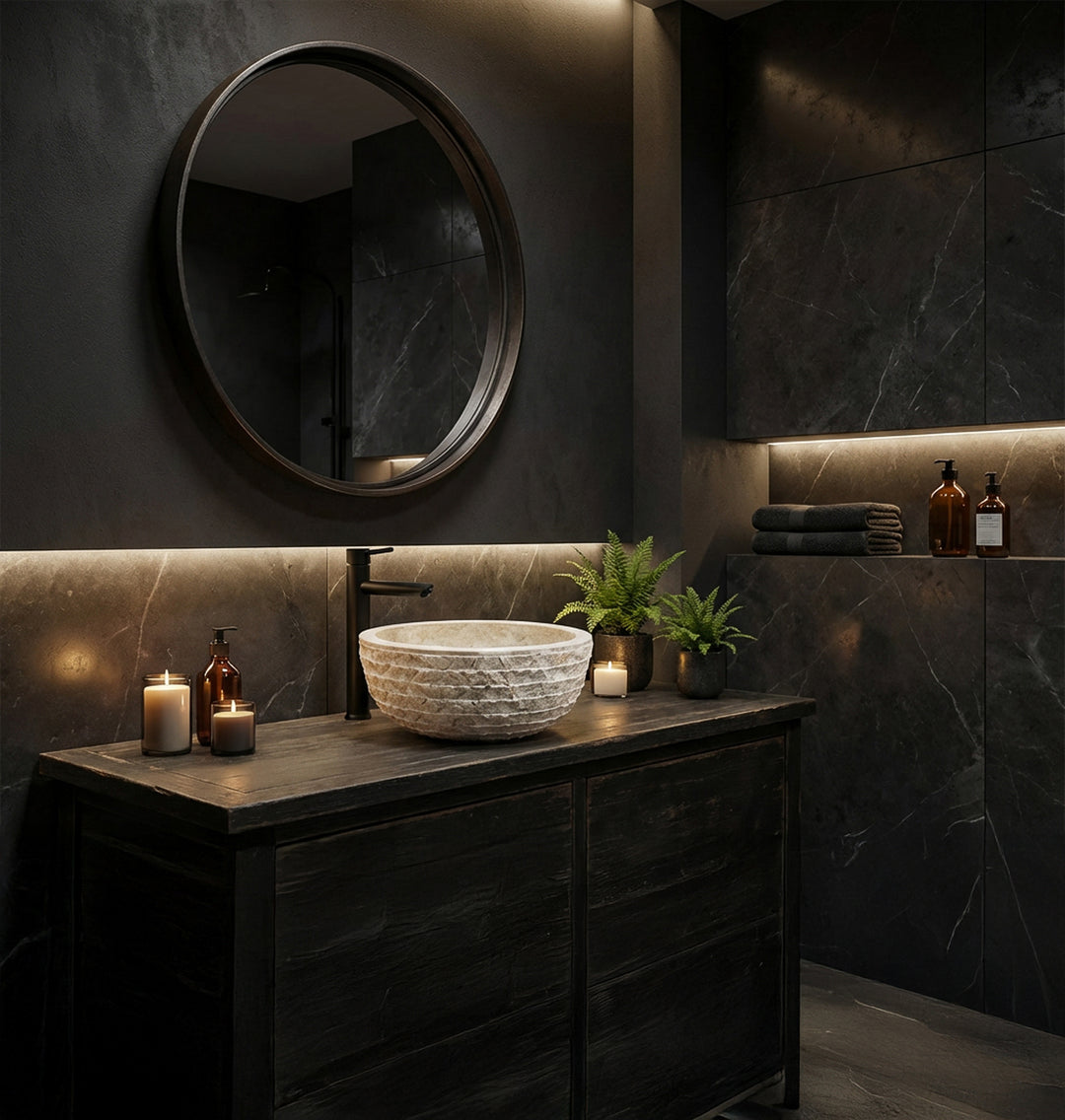 Elegant stone washbasin made of natural stone as a countertop basin on a dark vanity unit in the modern spa bathroom with candlelight