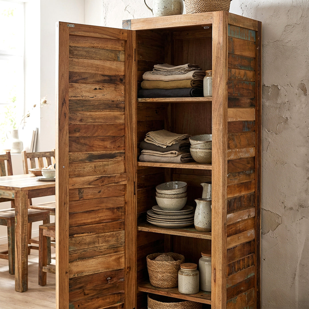 Narrow tall cabinet made of solid wood and reclaimed wood in vintage style, placed in the kitchen