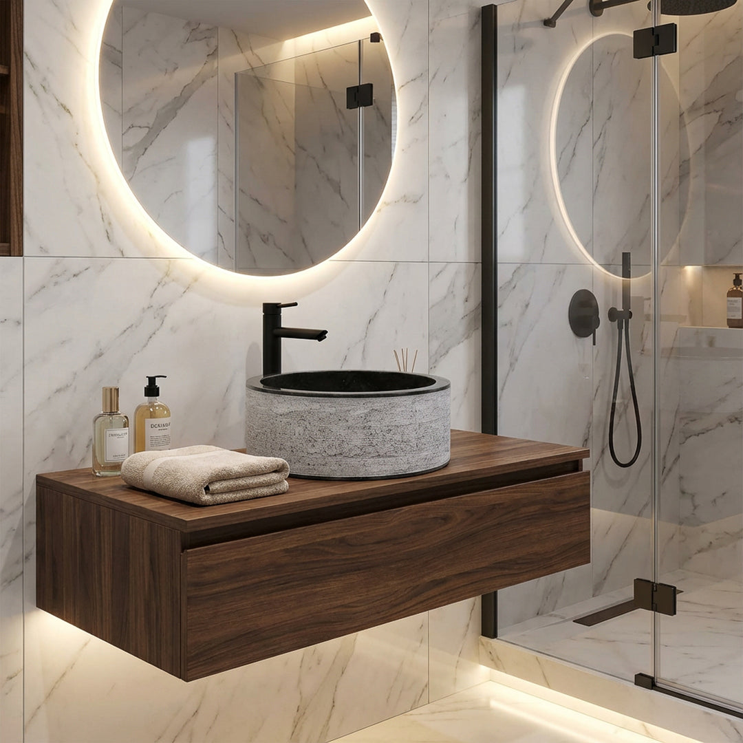 Round stone washbasin on a floating wooden console, modernly combined with black fittings in an elegant designer bathroom.