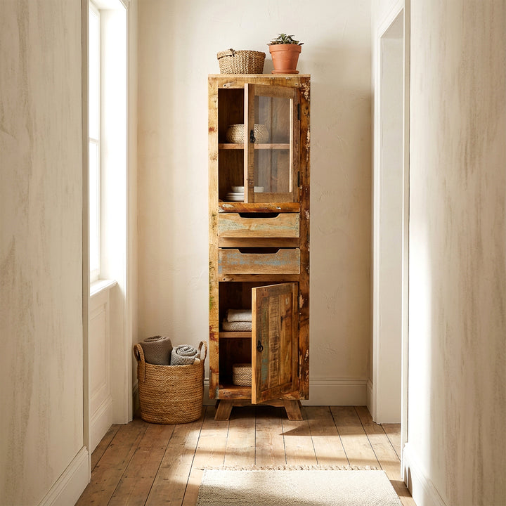 Display cabinet made of solid wood and old wood with drawer and doors in country house style, placed in the hallway